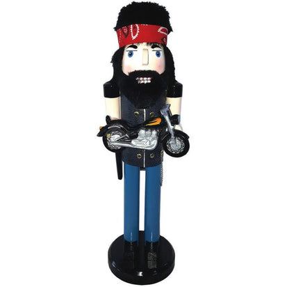 A biker nutcracker figurine with a black beard, red bandana, blue pants, and a motorcycle, standing on a black base against a white background.