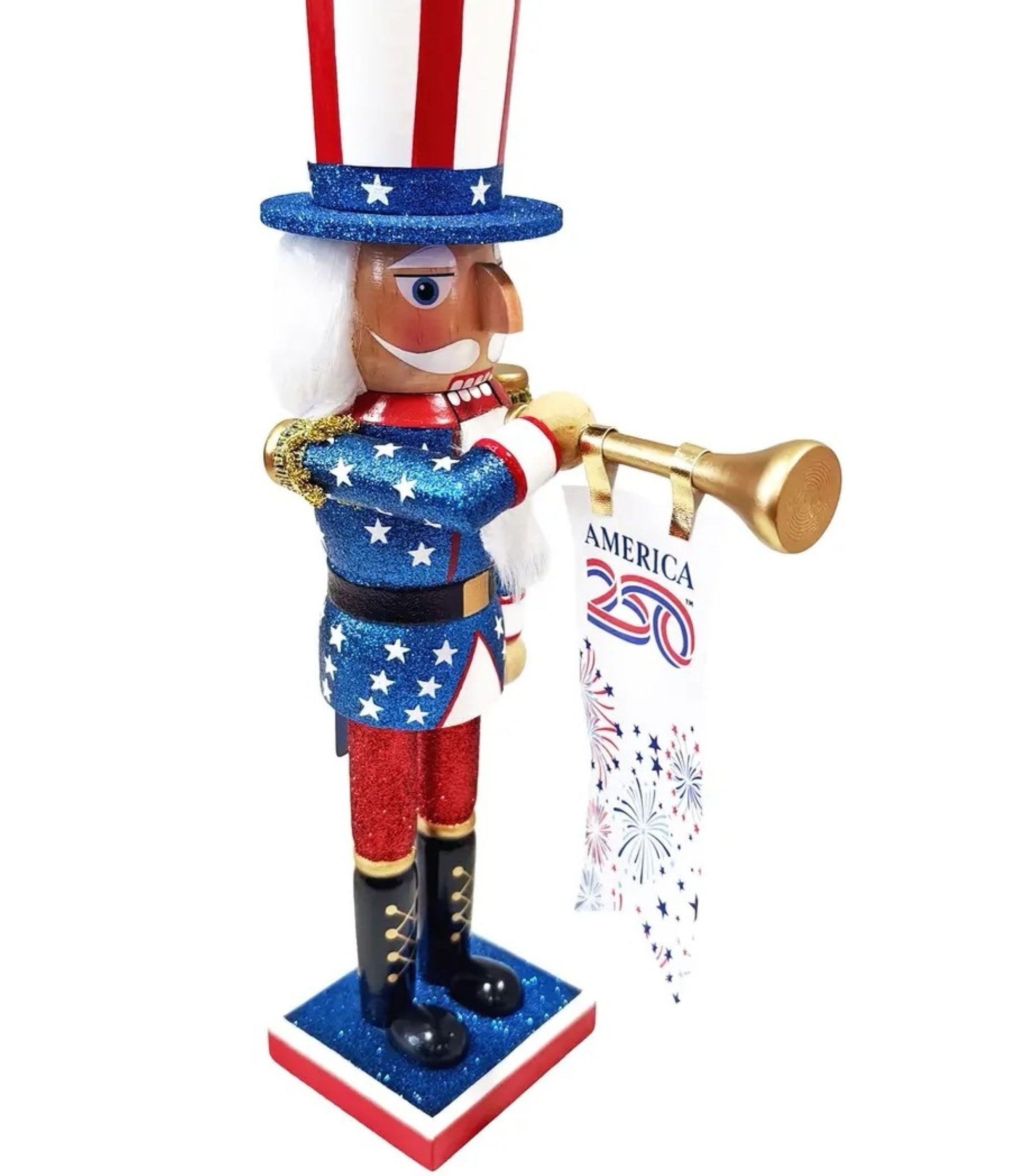 A patriotic Uncle Sam nutcracker figurine holding a gold trumpet and a banner that reads 'AMERICA 250' with fireworks graphics. The figurine features a red, white, and blue glittery design with white hair and a red, white, and blue striped hat, set against a plain white background.