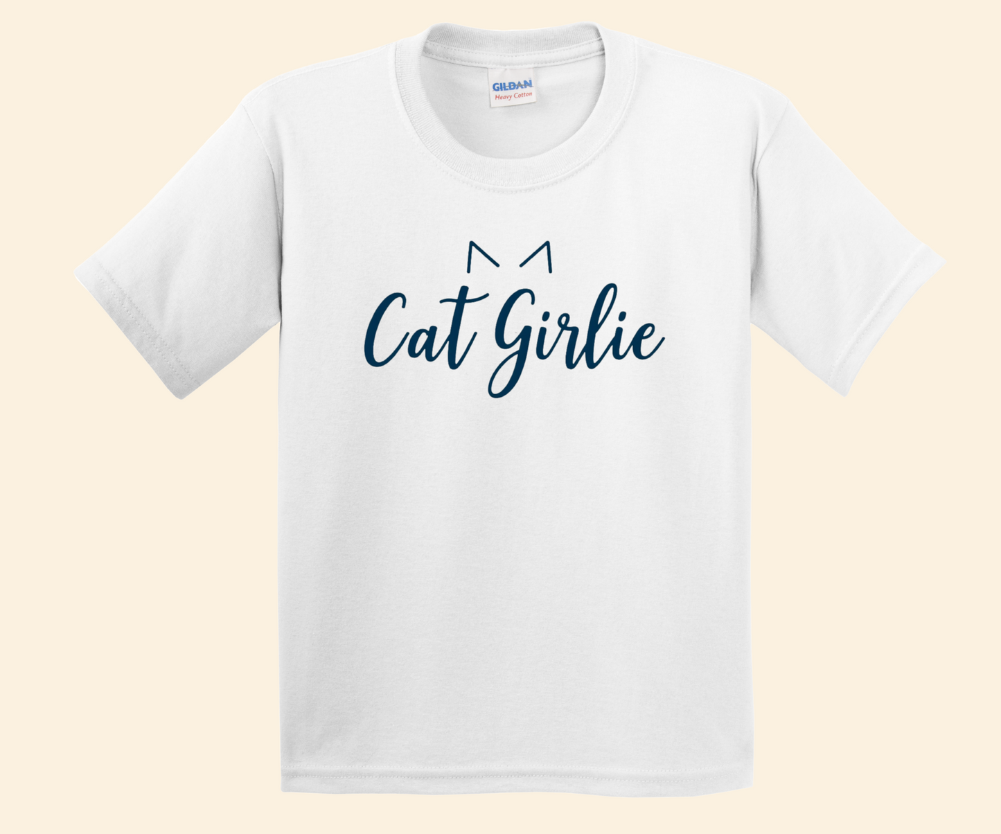 A white short-sleeve crewneck t-shirt featuring the text 'Cat Girlie' in dark blue script, with a simple cat ear graphic above the letters, displayed on a light beige background.