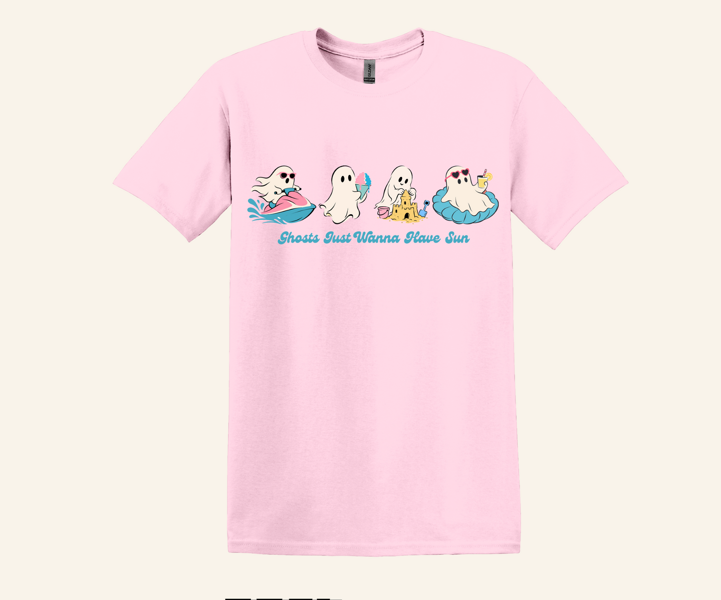 A light pink short-sleeve crewneck t-shirt featuring a cartoon graphic of four ghosts relaxing on pool floats with the text 'Ghosts Don't Wanna Have Sun' printed in blue script below them.