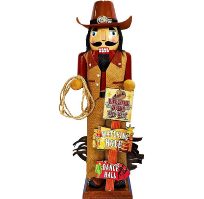 A rustic wooden cowboy nutcracker figurine holding a lasso and a sign that reads 'Welcome to Sombrero Land 1939'. It stands on a base with additional signs reading 'Watering Hole' and 'Dance Hall' against a plain white background.
