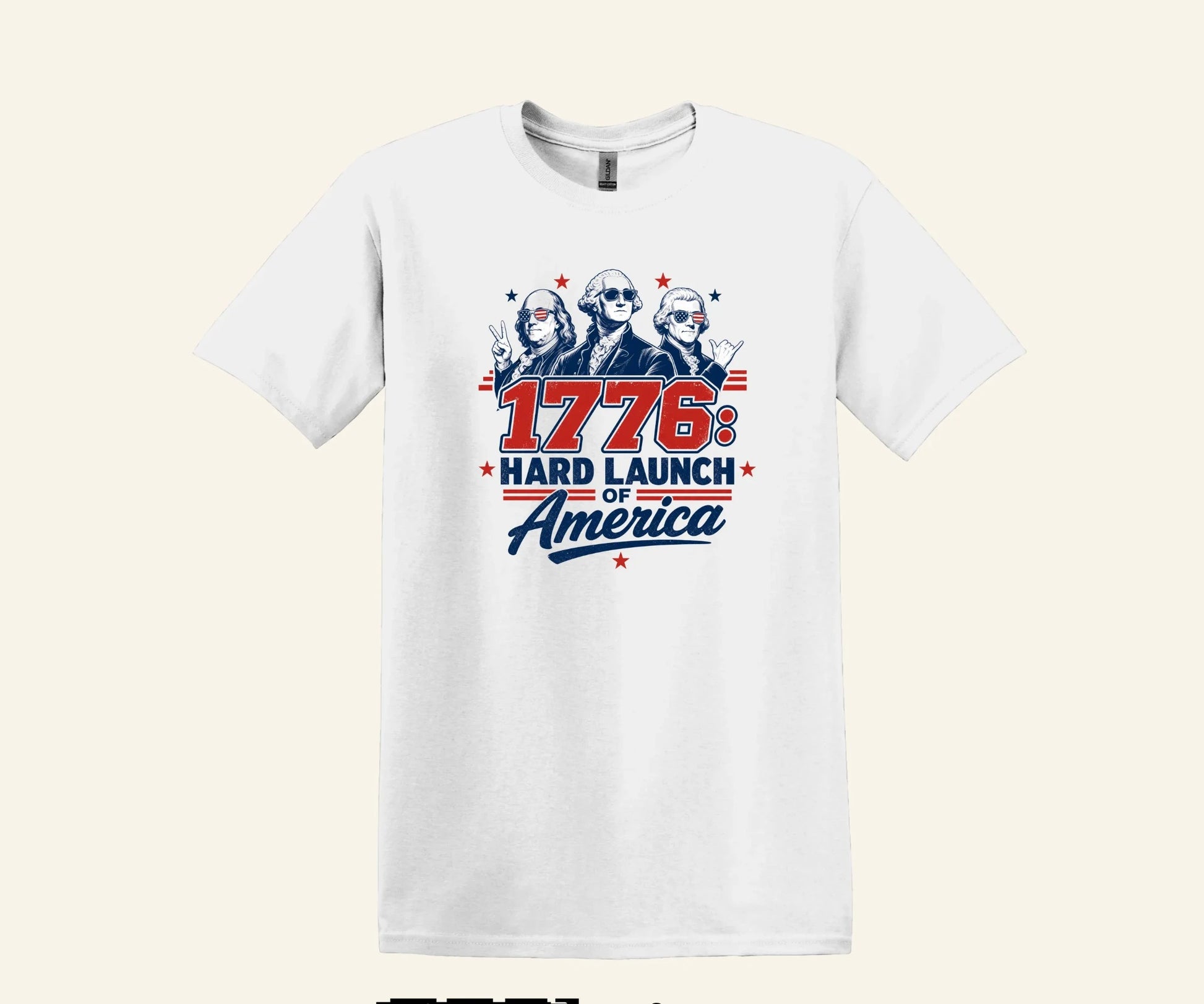 All I Need Designs white cotton t-shirt with 1776: Hard Launch of America graphic featuring founding fathers in sunglasses.