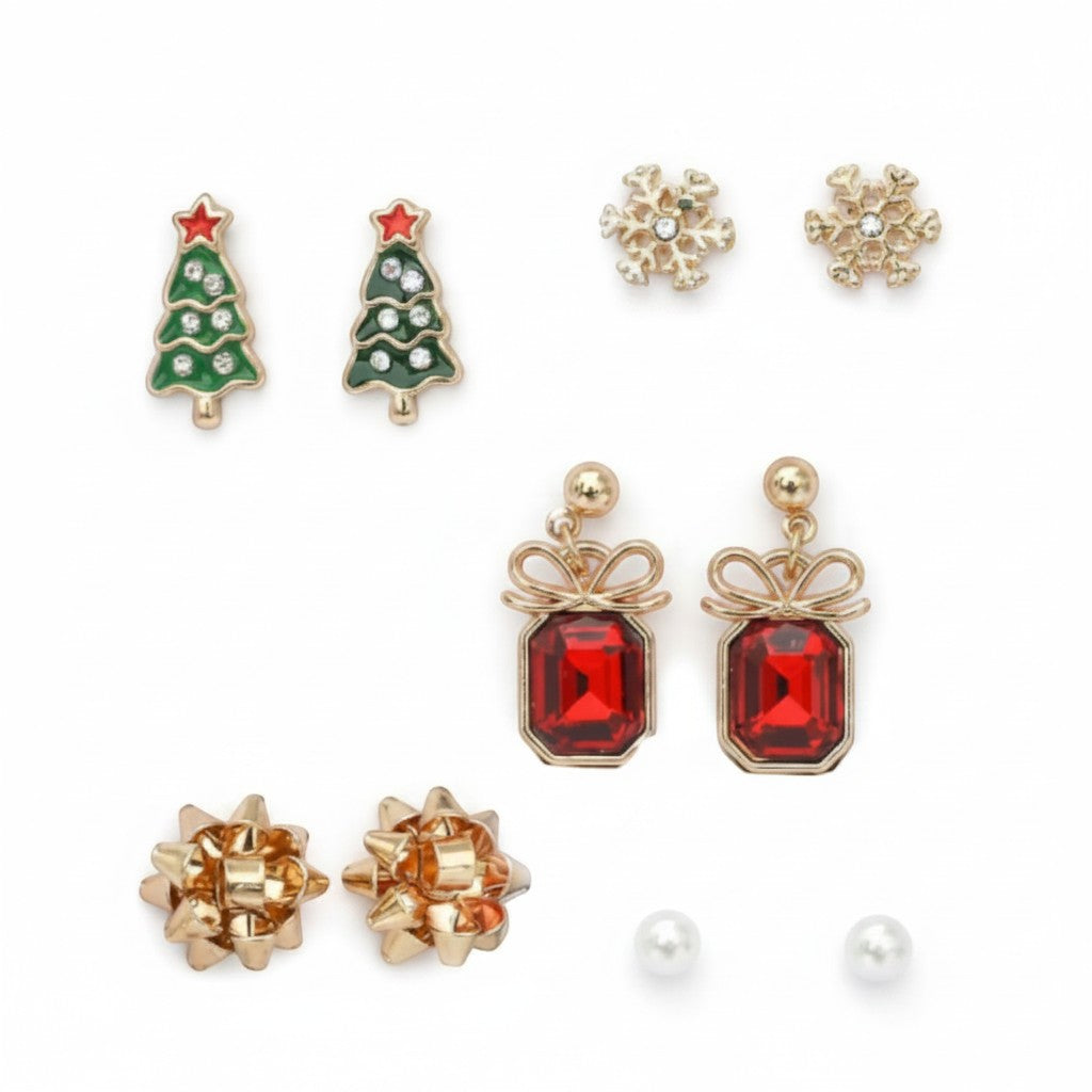 All I Need Designs 5-pair holiday earring set featuring Christmas trees, snowflakes, red gemstone presents, gold bows, and pearl studs.