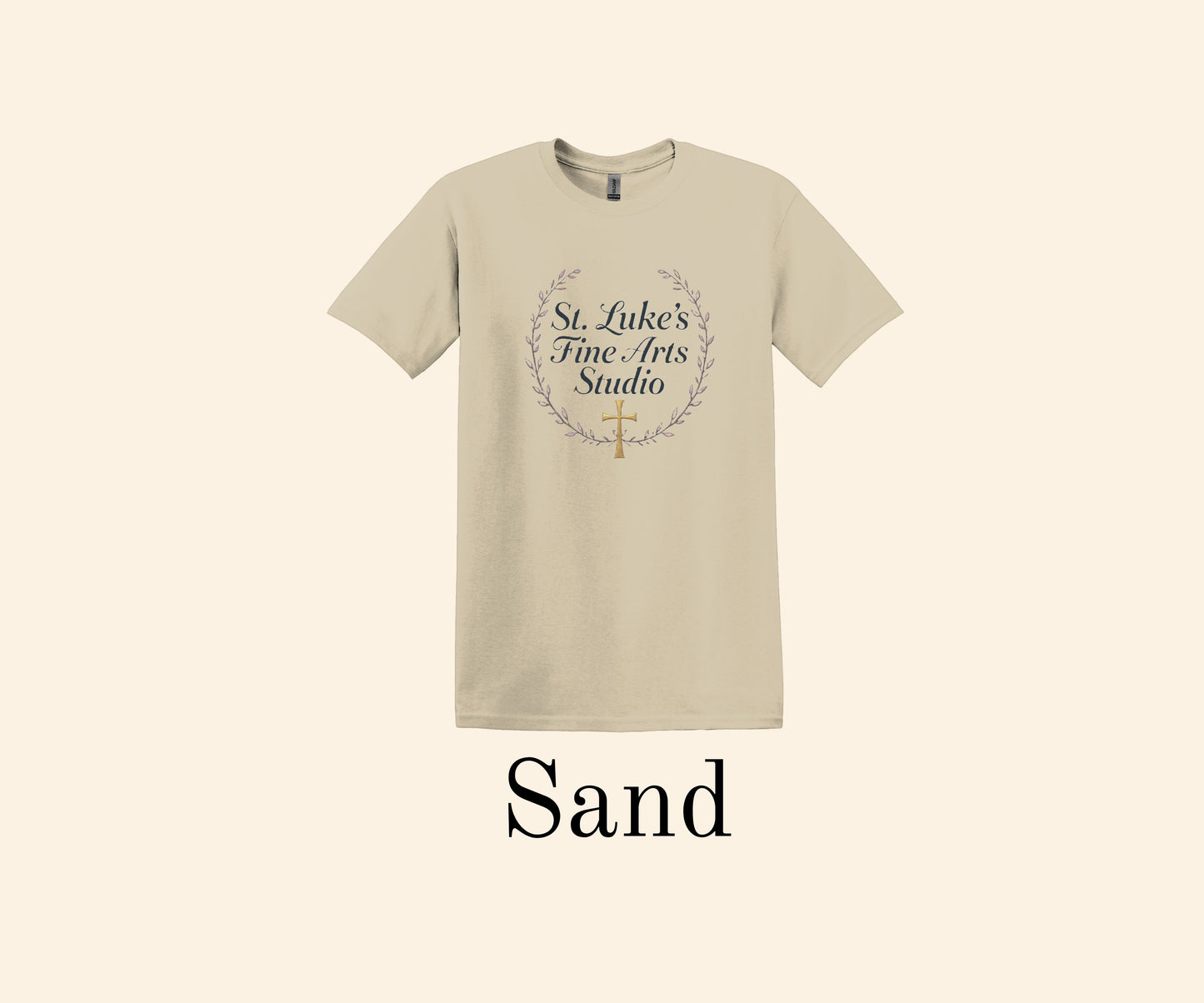 All I Need Designs sand cotton blend t-shirt with St. Luke’s Fine Arts Studio and gold cross design.