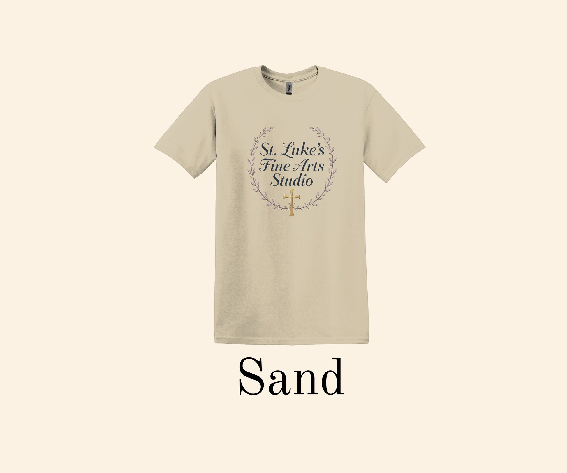 All I Need Designs sand cotton blend t-shirt with St. Luke’s Fine Arts Studio and gold cross design.