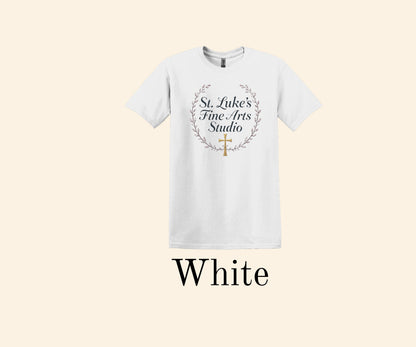 All I Need Designs white cotton blend t-shirt with St. Luke’s Fine Arts Studio text and gold cross within a laurel wreath.