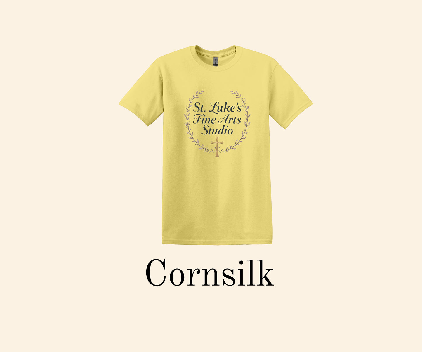 All I Need Designs Cornsilk yellow cotton blend t-shirt with St. Luke's Fine Arts Studio and gold cross design.